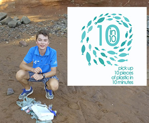 Oliver Baker on a beach with plastic that he has gathered up