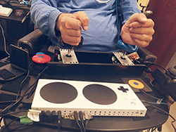Person using an adaptive game controller