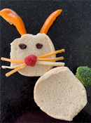 Bunny Sandwich 4 - Bunny shaped sandwich head and body made from circle cut bread, peppers for ears, raisins for eyes, raspberry nose, cheese for whiskers, broccoli for tail.