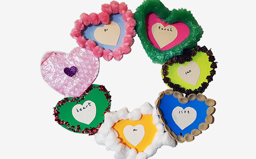 Wreath made from paper hearts with variety of tactile features and braille/print message.
