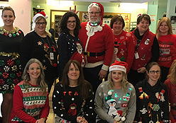 Staff wearing holiday sweaters