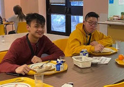 Students enjoying pancakes during breakfast