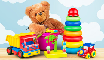 Children's toys including a plastic truck, car and a teddy bear sitting in a bucket.