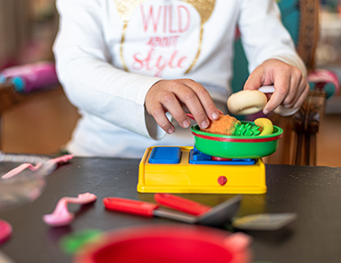 Child playing with toy food