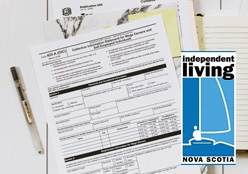 Documents and unfilled forms on a table with a pen and logo for Independent Living Nova Scotia