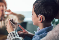 Smiling deaf boy learning sign language. Selective focus.